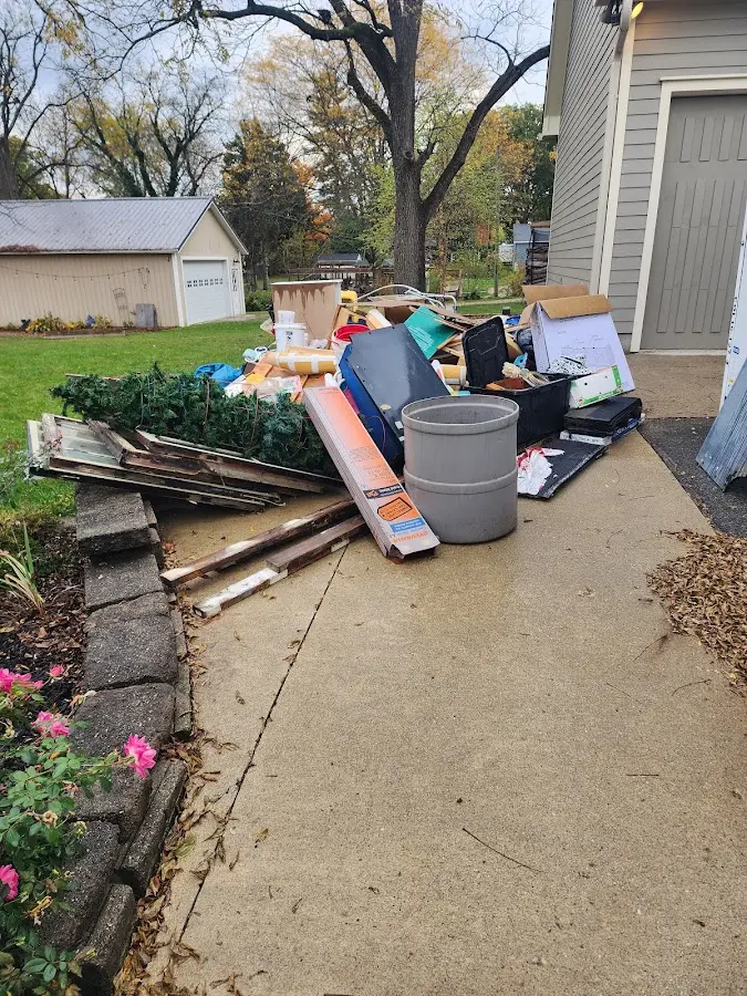 Dumpster being loaded with debris for Roofing Dumpster Rental in Ringgold